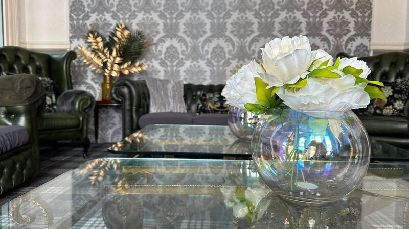 Fresh flowers on a glass coffee table in the lounge.
